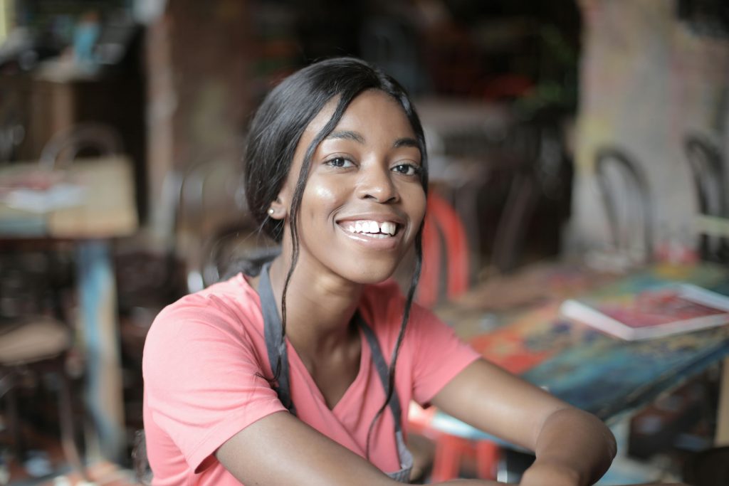 pexels photo 3801413 3801413 Joyful waitress in a vibrant cafe setting, showcasing hospitality.